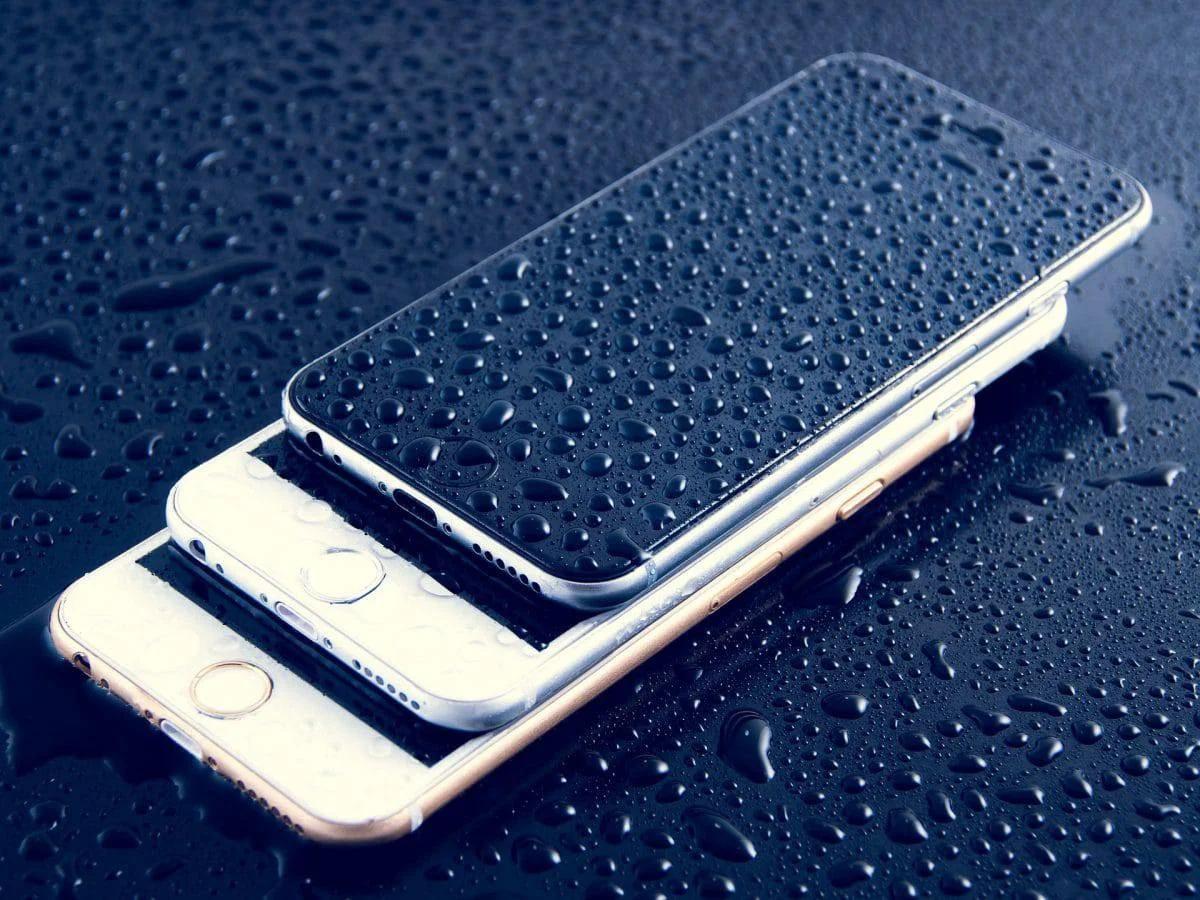 Phone with visible liquid damage next to its internal components